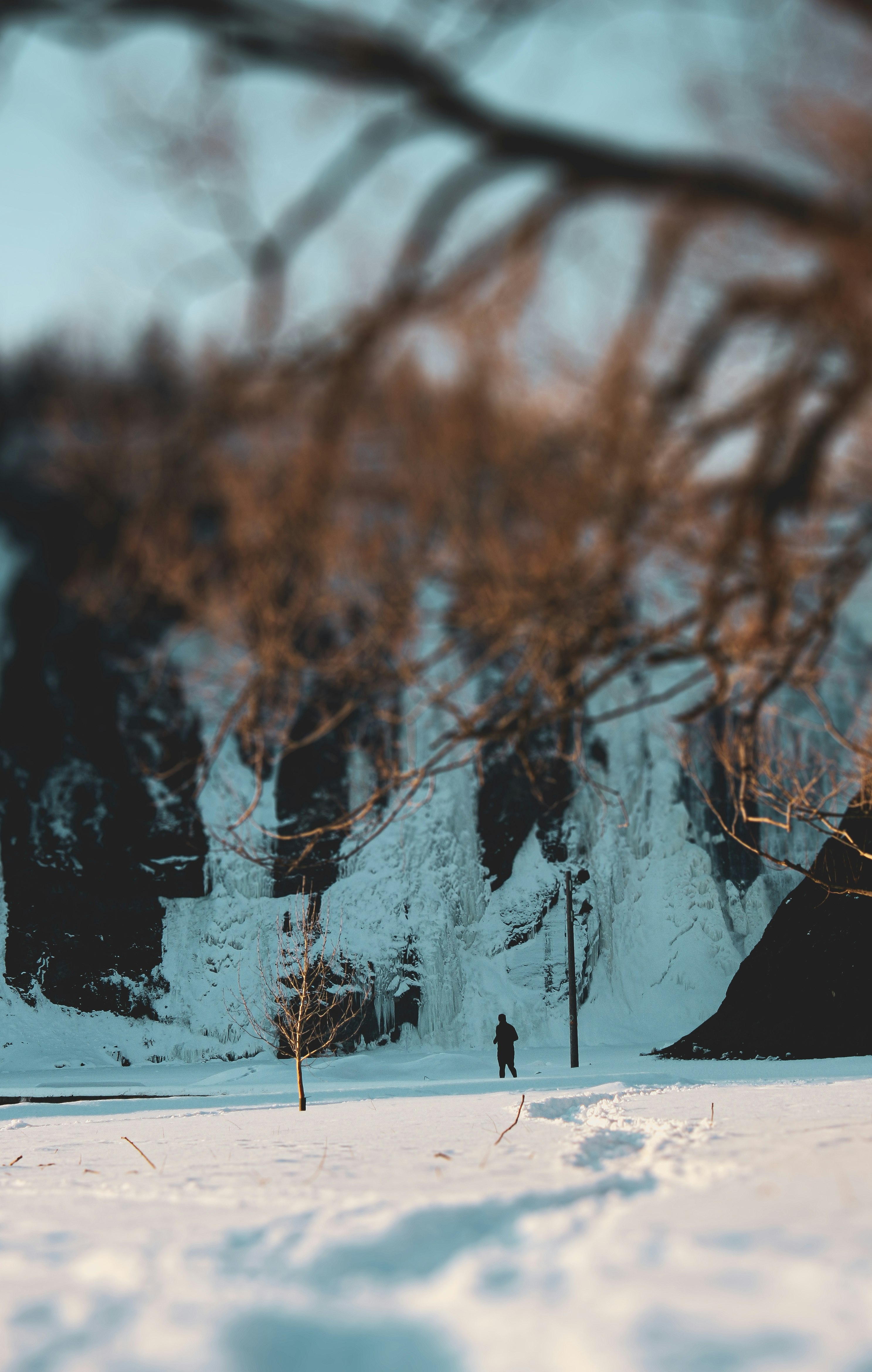 person walking on snow covered field during daytime